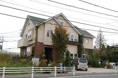 Green and brick House with cafe space